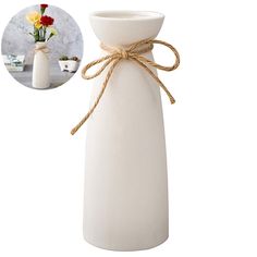 a white vase with rope tied around it and a photo of flowers in the background