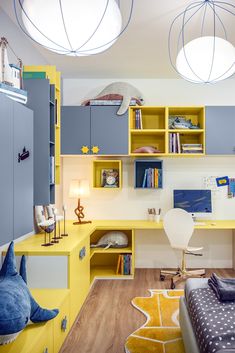 a bedroom with yellow and blue furniture in the corner, along with bookshelves