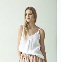 Short sleeveless linen blouse. Light, breathable and super clean - a must have during the warm season. Here simplicity really is the key: this white linen top gives you the room for pairing it with anything - skirts, pants, shorts, flats, heels, espadrilles... you name it. #whitelinentop #whitesummertop #whitesummerblouse #whiteoversizeblouse #oversizetop #summertop #whitelinenblouse #whitesleevelesstop Summer V-neck Camisole For Vacation, Summer Cotton V-neck Camisole, Cotton V-neck Camisole For The Beach, Summer Top With Spaghetti Straps, V-neck Summer Camisole For Vacation, Beach V-neck Cotton Camisole, Spring Linen Tank Top, Sleeveless Linen Tank Top For Summer, Linen Tank Top For Vacation