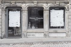 an old building with two large windows covered in snow