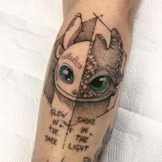 a tattoo on the leg of a person with green eyes