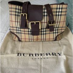 Burberry Classic Large Tote With Buckle Bag. You Can Either Use It As Shoulder Bag Or Just Like A Carry On Bag. It’s In A Very Clean And Perfect Condition. 100% Authentic Guaranteed! Includes A Very Clean Dust Bag. Measurements: Length - 15” Height - 10” Width - 7” Strap Drop - 8.75” Condition: Good Used Condition. Shows Very Very Very Light Wear. The Handles Are Relaxed. Interior Shows No Marks And Wear It Very Clean. Tons Of Life! Best Offer Accepted Burberry Handbags Classic, Offer Accepted, Buckle Bag, Burberry Classic, Buckle Bags, Bag Measurements, Burberry London, Carry On Bag, Burberry Bag