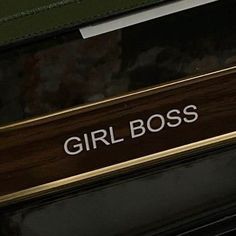 the girl boss sign is on the side of a car