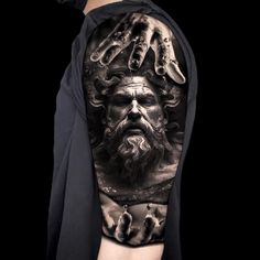 a man's arm with an image of the god and his hands on it