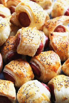 hotdogs wrapped in bread and sprinkled with poppy seeds