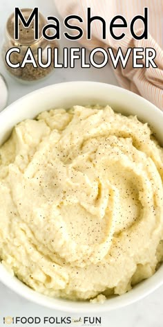 mashed cauliflower in a white bowl with text overlay