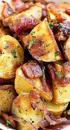 a white plate topped with potatoes covered in bacon