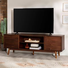 a flat screen tv sitting on top of a wooden entertainment center