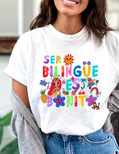 ---------- Design ----------- What is more bonito than being bilingüe? This t-shirt features images and letters that are inspired by Karol G's album "Mañana Será Bonito. It is bight and bold and identifies your super power for all to see. Go ahead, show off! Please note that the colors may not be as bright as they are in the photos ---------- Product ---------- .: The Comfort Colors 1717 tee is made with medium fabric consisting of high quality, 100% ring-spun US cotton for long-lasting comfort. .: The relaxed fit keeps the wearer comfy in both casual and semi-formal settings while the crew neckline delivers that classic, neat style. .: The pre-shrunk fabric ensures a consistently great fit. .: Made using 100% US cotton that is ethically grown and harvested. ---------- Production & Shippin Casual Multicolor T-shirt With Funny Text, Cute Multicolor T-shirt With Slogan, Cute Multicolor Slogan T-shirt, Fun Multicolor T-shirt With Text Print, Multicolor Funny Text T-shirt, Elementary Teacher, Teacher Tshirts, Super Powers, Comfort Colors