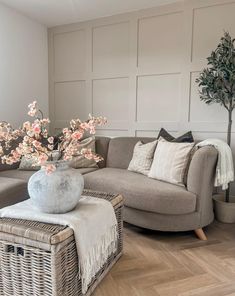 a living room filled with furniture and a large vase on top of a coffee table