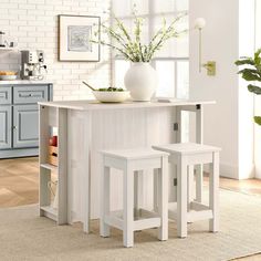 a white kitchen island with two stools next to it