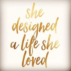 the words she designed a life she loved in gold foil on a white background with a black