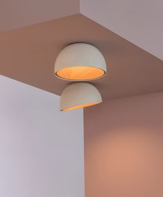 two lamps that are hanging from the ceiling