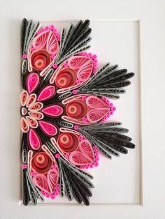 an art piece with pink and black designs on white paper, framed in a white frame