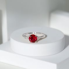 Product Details Bring a touch of sparkle to your everyday with this Created Ruby Engagement Ring. Featuring a trio of dazzling Diamond and a stunning center stone of created ruby, this ring is the perfect way to show your love and make your special someone feel appreciated. Product Information SKU SHP-RINGS0821184508 Width 4 mm Height 6.5 mm Weight 1.60 gm (Approximate) LAB CREATED RUBY INFORMATION No.of Stones 1 Pieces Total Weight 1.30 Carat (Approximate) Dimension(approx) Round-7X7 mm-1 Pcs C