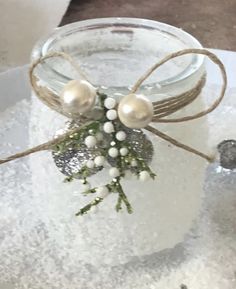 a glass jar filled with snow and white balls