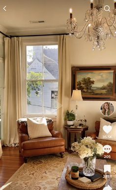 a living room filled with furniture and a chandelier hanging from the ceiling next to a window