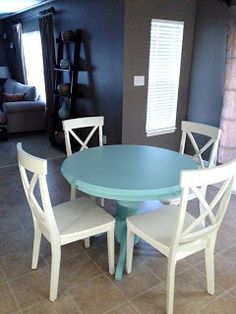 a dining room table with four chairs around it