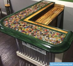 a green table topped with lots of buttons on top of a metal radiator