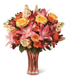 a vase filled with orange and pink flowers