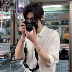 a man taking a selfie in front of a mirror with a camera attached to his neck