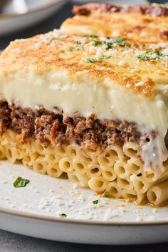 a close up of a plate of food with lasagna and cheese on it