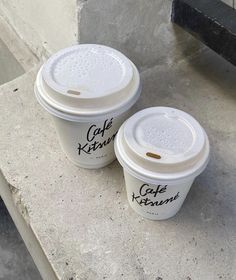 two cups of coffee sitting next to each other