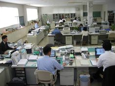 an office filled with people working at desks