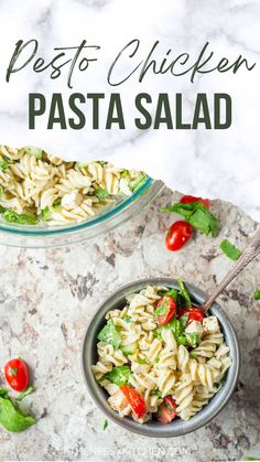 pasta salad with pesto chicken in a bowl on a marble countertop next to another dish