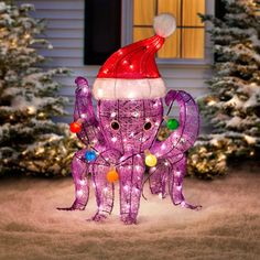 an inflatable purple octopus with a santa hat on it's head and lights around its neck