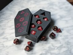 two black and red dices sitting on top of a marble table next to each other