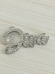 "You will receive 1 Diva script word charm - pendant - choose color from drop down menu 1 Diva beautiful CZ charm - pendant - 3 colors - pave cubic zirconia rhinestones Pave CZ rhinestones 18k over gold plated, rhodium plated and black metal plated - word charms Choose from 3 colors: Rose gold w/clear CZ stones Silver w/clear CZ stones Black/black CZ stones CZ Diva Very nice quality Shiny cubic zirconia stones Measures approx 40mm w/loop x 25mm (approx 1-1/2\" x 7/8\") Although I try hard to rep Luxury Cubic Zirconia Heart Charm Jewelry, Cubic Zirconia Heart Pendant Jewelry With Charm, Silver Cubic Zirconia Charm Necklaces, Tarnish Resistant, Heart-shaped Cubic Zirconia Charms Jewelry, Adjustable Heart-shaped Cubic Zirconia Bracelet, Alphabet Charms, Z Photo, Cz Stone, Black Metal