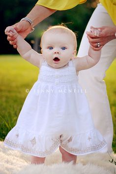 a baby is holding her mother's hand