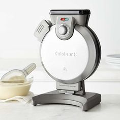 a blender sitting on top of a counter next to a bowl