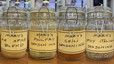 several jars with labels on them sitting on a table