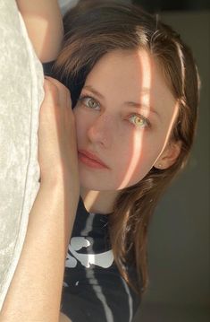 a woman with her hand on the wall