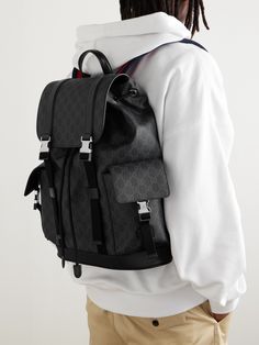 Gucci was founded in 1921 as a destination for luggage, and it remains a go-to more than 100 years on. This backpack is made from Supreme coated-canvas and has two adjustable straps in navy and red. The buckle fastening top opens to a spacious interior with room for your gym kit and tech – we'd use it day-to-day. Gucci Classic Backpack, Classic Gucci Backpack, Luxury Bags With Pockets In Monogram Canvas, Luxury Gucci Backpack, Luxury Travel Backpack With Leather Trim, Classic Gucci Backpack For Travel, Classic Gucci Travel Backpack, Designer Gucci Backpack, Luxury Leather Coated Canvas Backpack For Travel