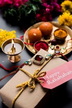 a gift wrapped in brown paper sitting on top of a table next to other items