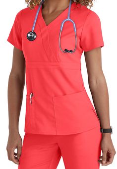 No matter your caregiving profession, we think you'll love this Grey's Anatomy 3-pocket mock-wrap scrub top especially in the vibrant Papaya color! | Scrubs & Beyond Medical Student Outfit, Greys Anatomy Shirts, Student Outfit, Scrub Style, Cute Scrubs, Womens Scrub Tops, Greys Anatomy Scrubs, Scrubs Outfit, Nursing Fashion