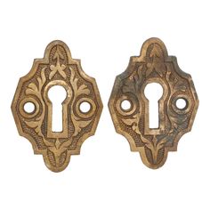 two antique brass door knobs with ornate designs on them, one is open and the other has a keyhole