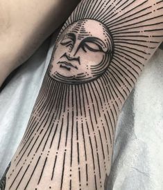 a person with a sun tattoo on their arm