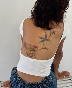 a woman with a flower tattoo on her back