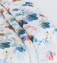 an image of a flowered bed sheet set with blue and pink flowers on it