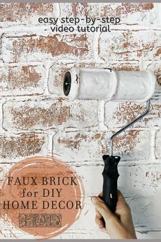 a person holding a paint roller in front of a brick wall with the words faux brick for diy home decor