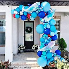 a blue balloon arch in front of a house