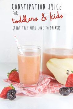 a glass filled with liquid next to some fruit