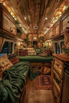 the interior of a camper with wood paneling and green bedding on it