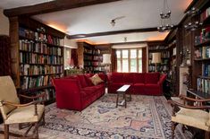 a living room filled with lots of furniture and bookshelves