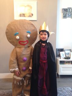 two children in costumes standing next to each other