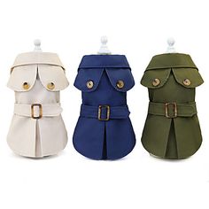 three different colored dog coats with buckles on each side and one in the middle